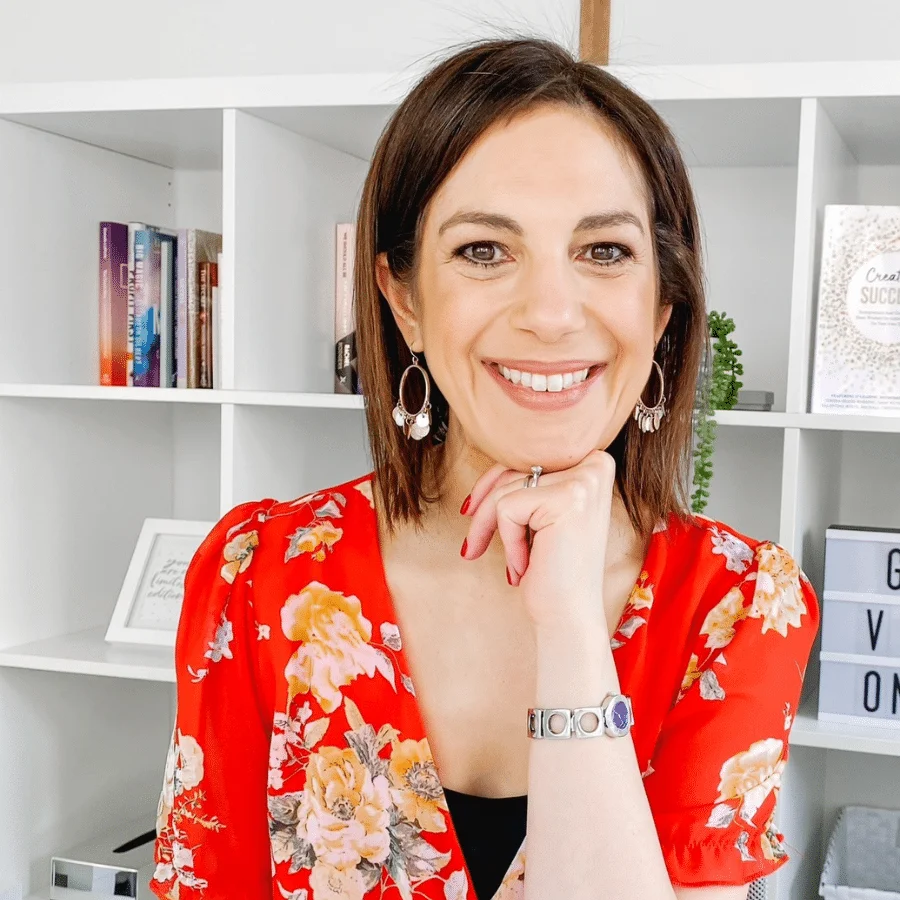 A woman DAMN manifesto in front of a bookshelf.